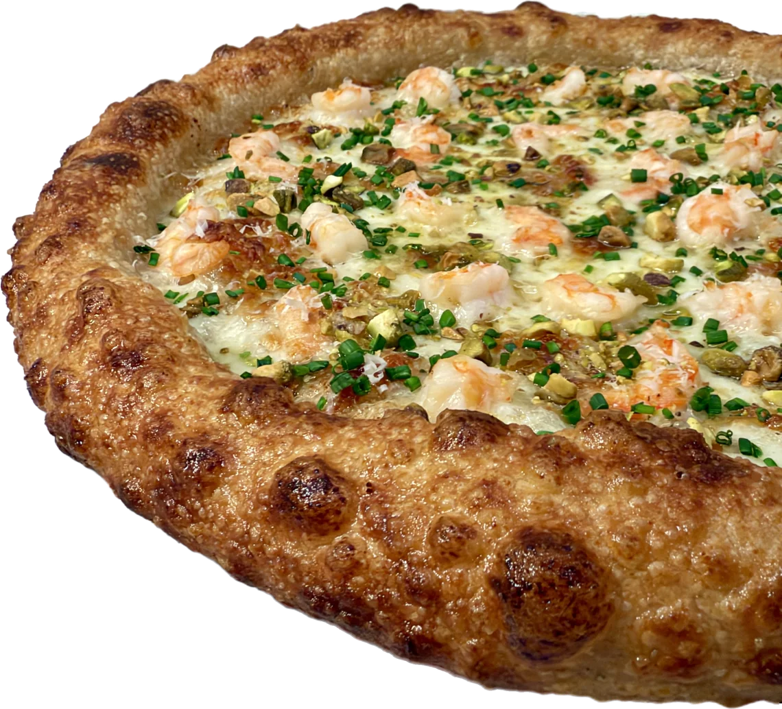 The rim of a Scampi Spur pizza, tall, puffy, and leopard-spotted.